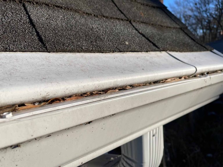 solid gutter cover which is a plastic or PVC material installed on top of a white 6-inch gutter