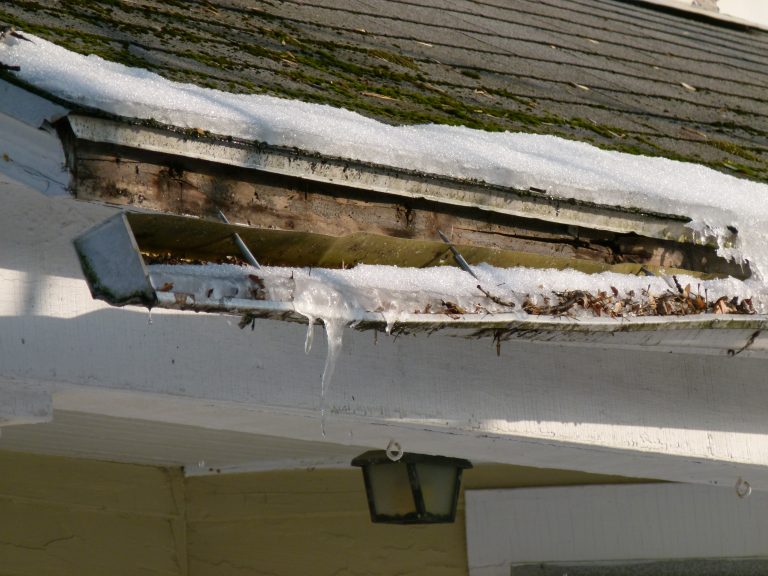 Gutter dislodged from facia boards by snow, ice and leaves