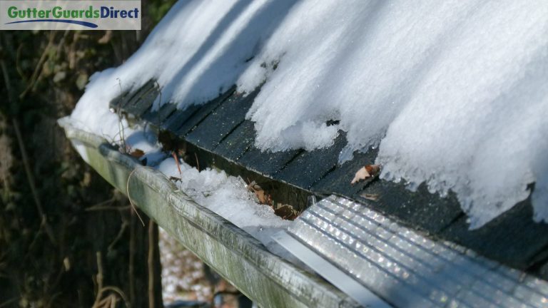 microscreen gutter guards installed next to ice filled gutters