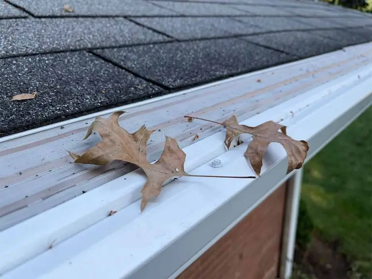 mastershield micro mesh gutter guards installed on 6" gutters with a couple of oak leaves loosely resting on the cover's stainless steel and copper micro mesh screen