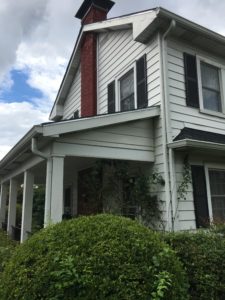 photo showing gutters on the side and front of the home with microscreen gutter guards installed over the existing gutters