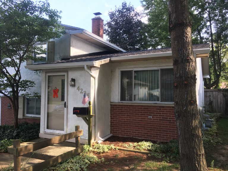 split level home with new roof gutters and gutter guards in Whitehall Ohio