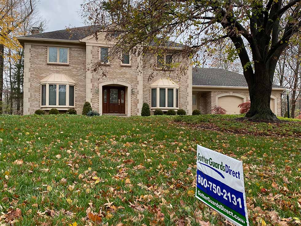 photo of a 2 level, blonde brick home with 6-inch clay gutters and mastershield gutter guards in loveland, ohio