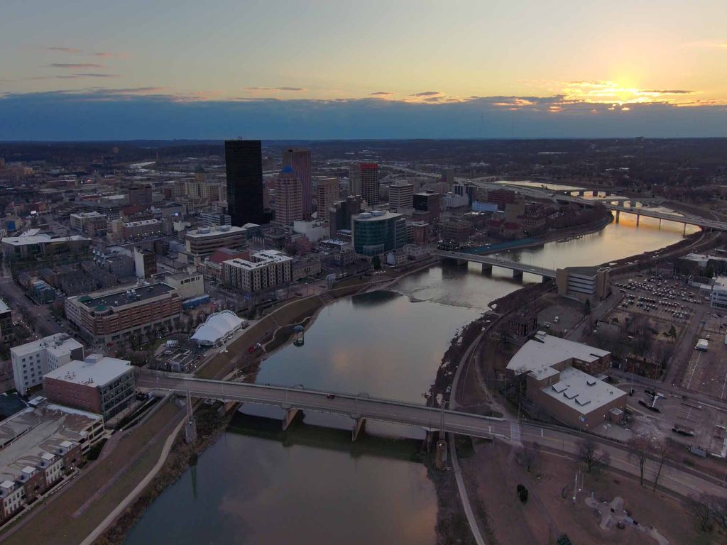 drone shot of the downtown dayton skyline at sunset looking across the river from northeast to southwest